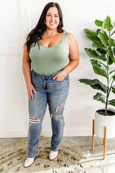 Mid Rise Bootcut Judy Blue Jeans With Plaid Patch Detail.